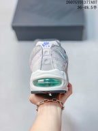 Rear view of a Nike Air Max 95 sneaker showing the translucent green heel Air window.