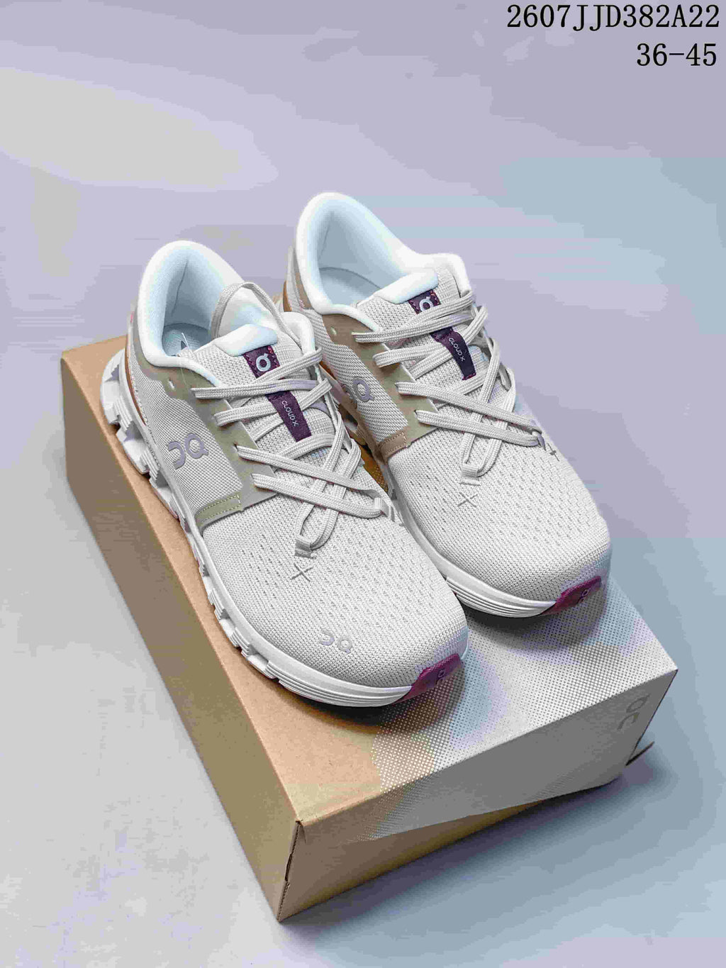 Pair of light gray On Cloud X 4 sneakers displayed on a shoebox, with style code 2607JJD382A22 and size range 36-45 visible at the top.