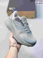 Angled side view showing the gray upper, pale green accents, lace closure and textured midsole.