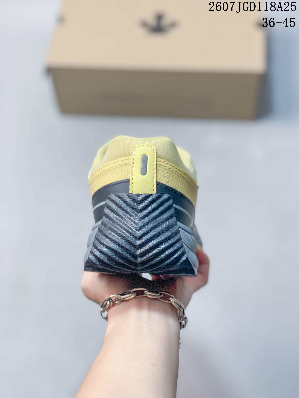 Rear view of the sneaker showing the black textured heel section and yellow collar.