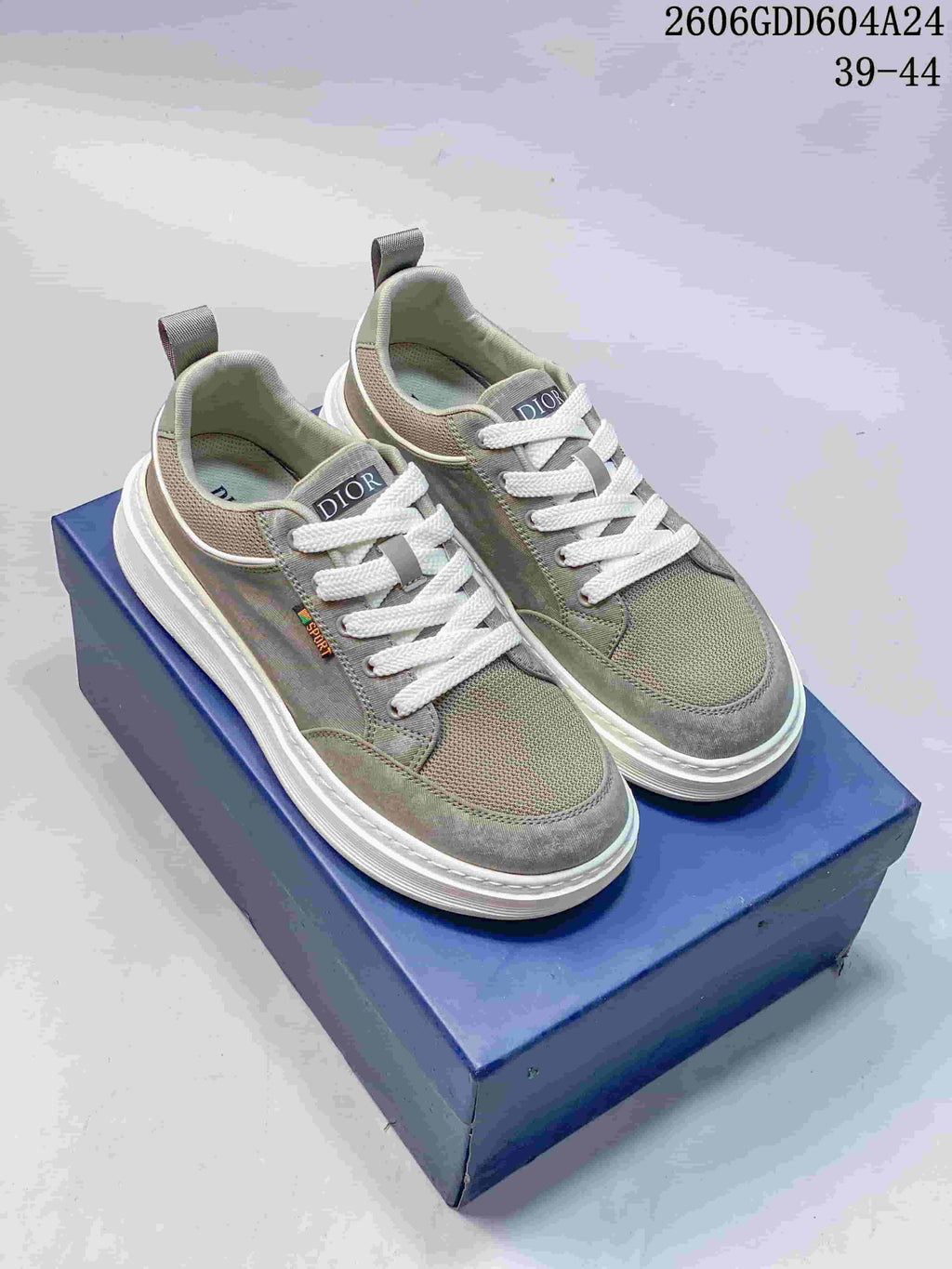 Pair of gray-green Dior lace-up sneakers with white laces and thick white soles