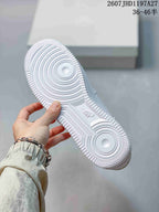 Close-up of the white rubber outsole showing concentric forefoot grooves, textured edges, and Air branding.