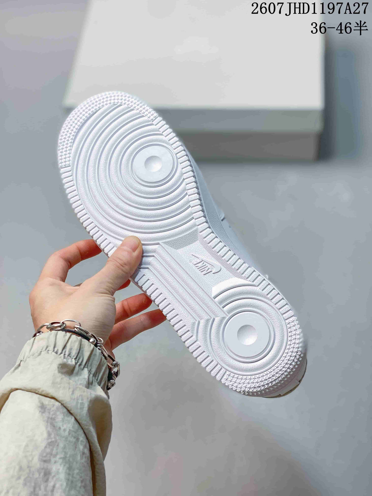 Close-up of the white rubber outsole showing concentric forefoot grooves, textured edges, and Air branding.