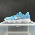 Side view of a blue low-top Nike sneaker with a white side logo and ridged white sole