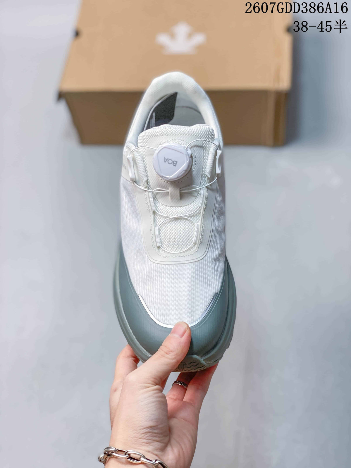 Top view of one sneaker showing the white upper, gray toe guard, tongue, and round dial closure.