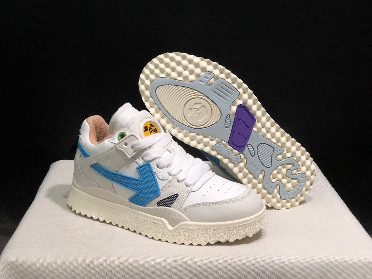 Angled view of one sneaker with the outsole exposed, showing its textured cream-colored base and colored traction sections.