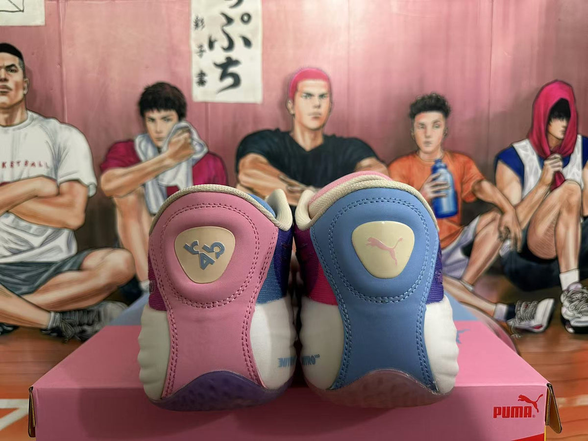 Rear view of pink and blue PUMA basketball shoes with contrasting heel details on a pink box.