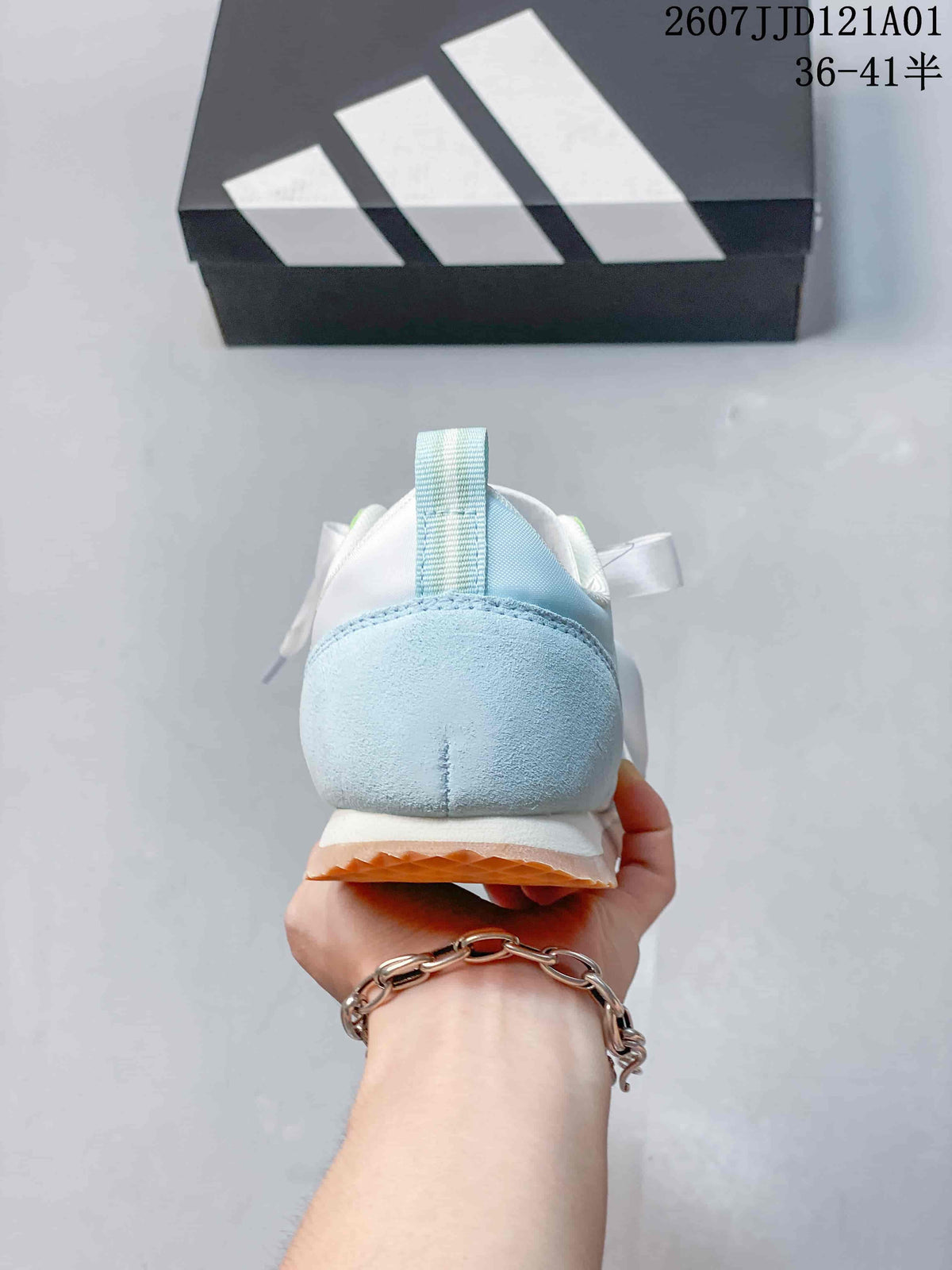 Rear view of a pale blue and white adidas JOG 2.0 sneaker