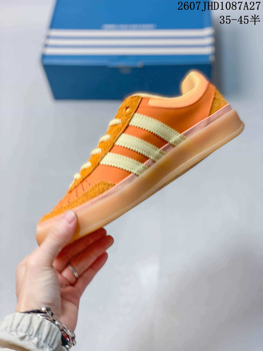 Side profile showing the low-top silhouette, three stripes and gum-colored sole.