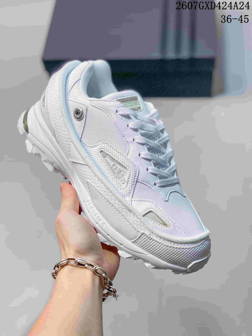 Close-up of a predominantly white OZWEEGO sneaker with pale lavender accents and a textured toe and outsole.