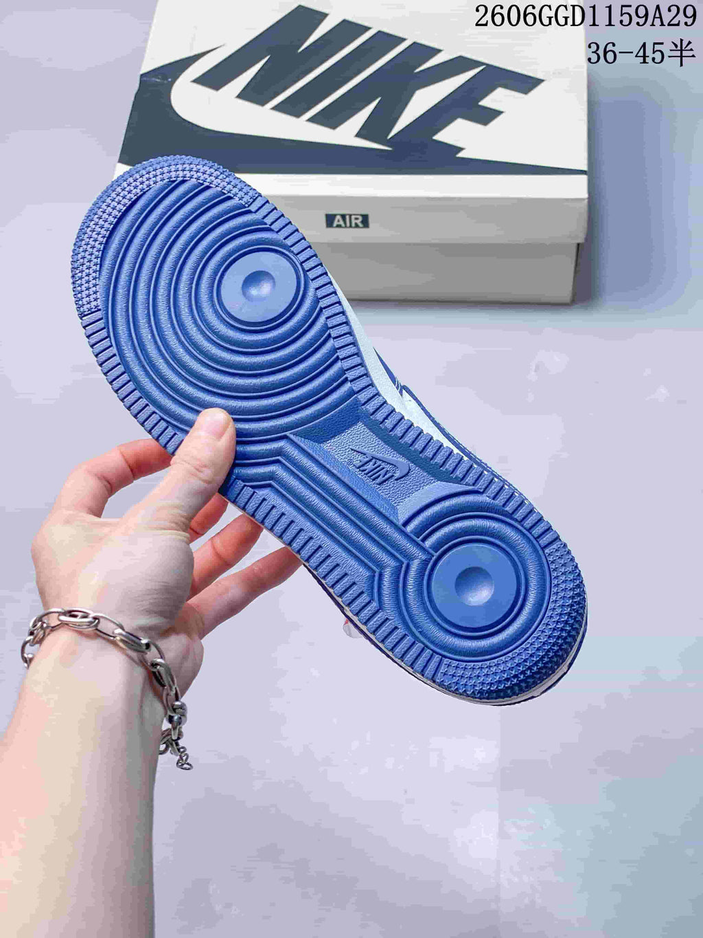 Blue outsole of the sneaker showing circular tread patterns and textured edges.