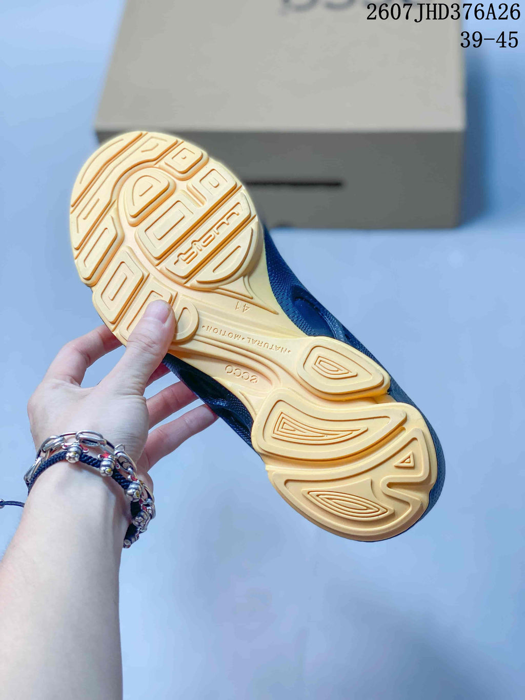 Close-up of the tan outsole showing its molded tread pattern and visible ECCO branding.