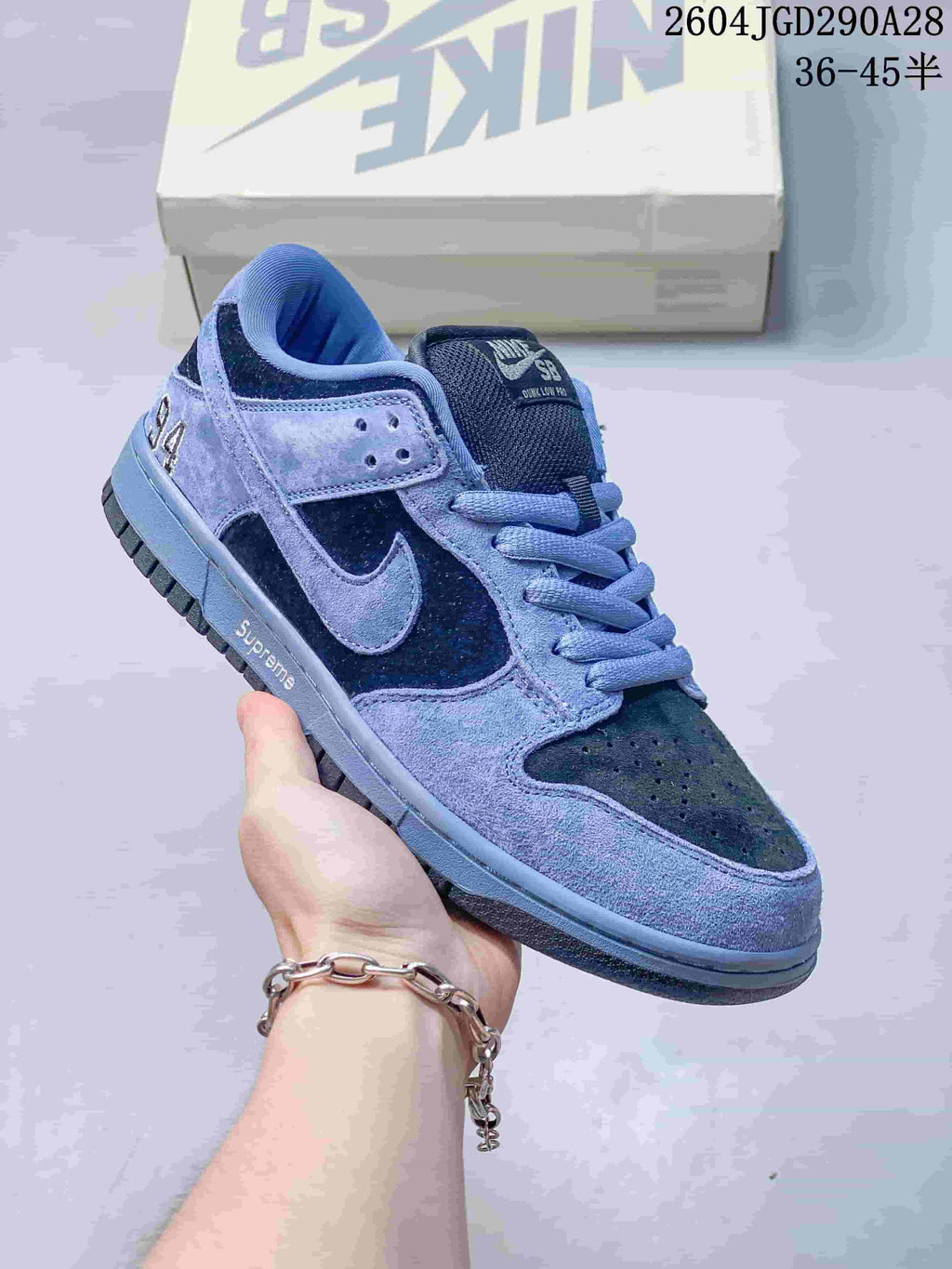 Blue and navy Nike Dunk Low sneaker with contrasting panels; image overlay shows sizes 36–45.5.