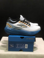 Side view of the white and blue Brooks Glycerin 21 sneakers with orange accents, displayed on a Brooks shoebox.