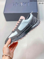 Side profile of the sneaker showing the layered gray and white upper, Dior side detail, speckled midsole, and lugged outsole.