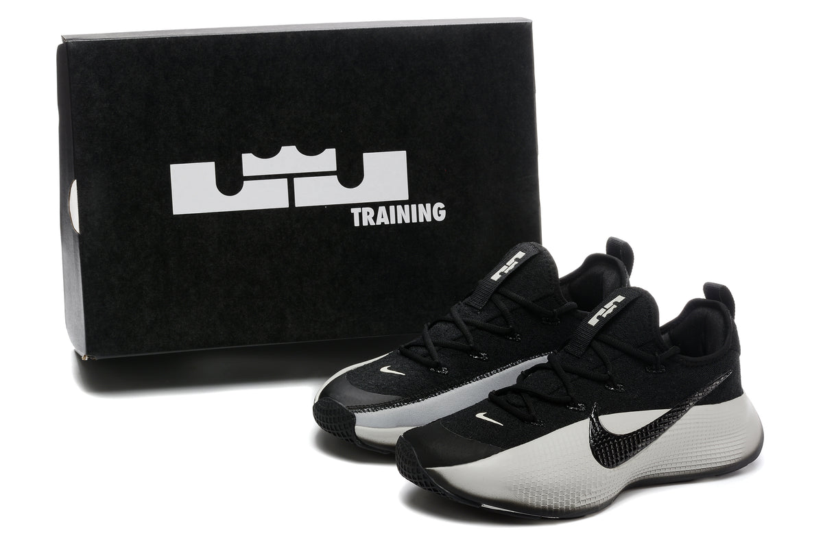 Pair of black and white shoes beside a black box marked with LeBron and TRAINING graphics.