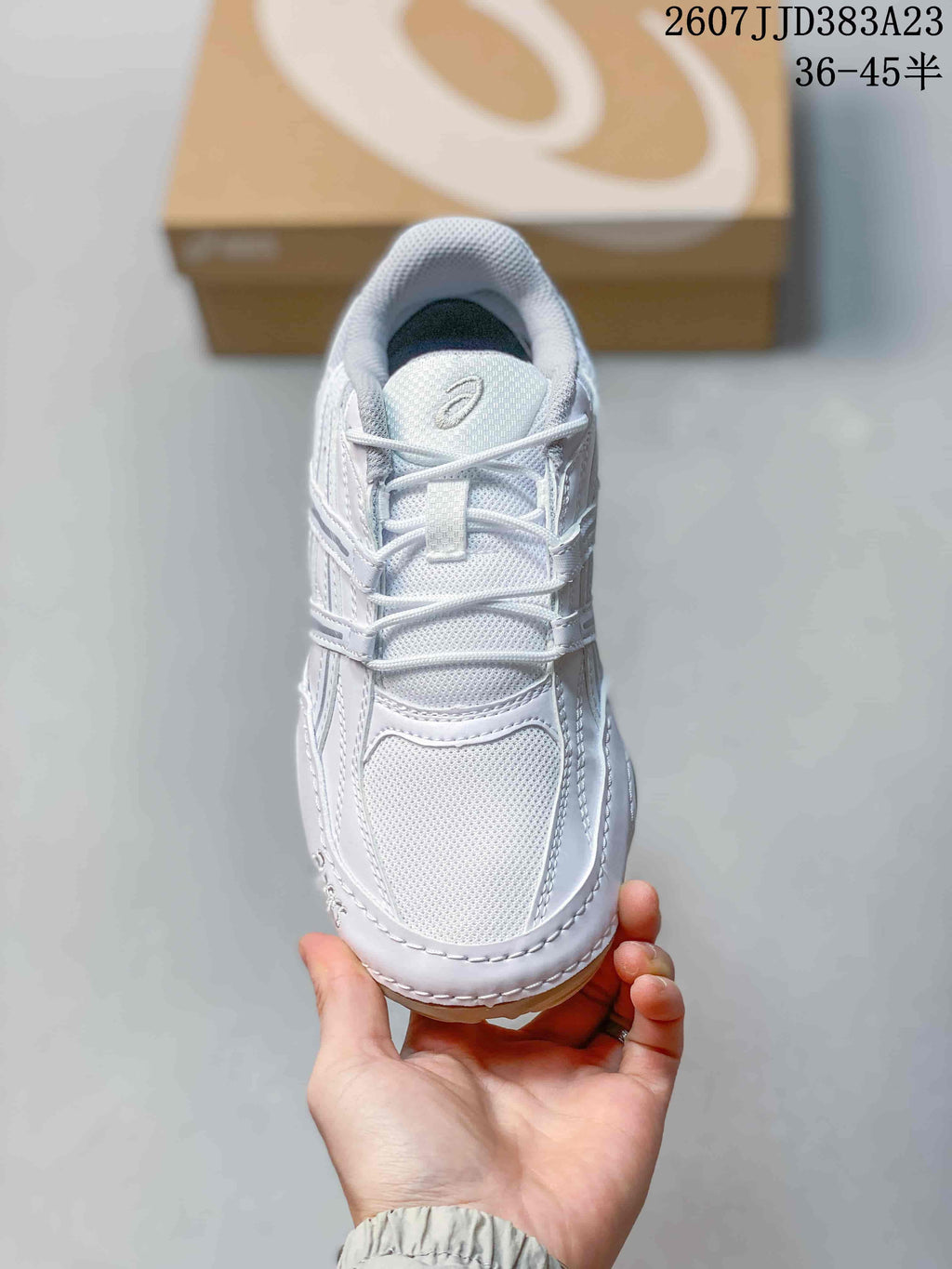 Top view of the white sneaker showing the mesh toe box, layered upper and lace-up closure.