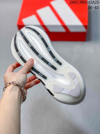 Close-up of the white sneaker outsole showing raised white sections and dark textured traction strips.