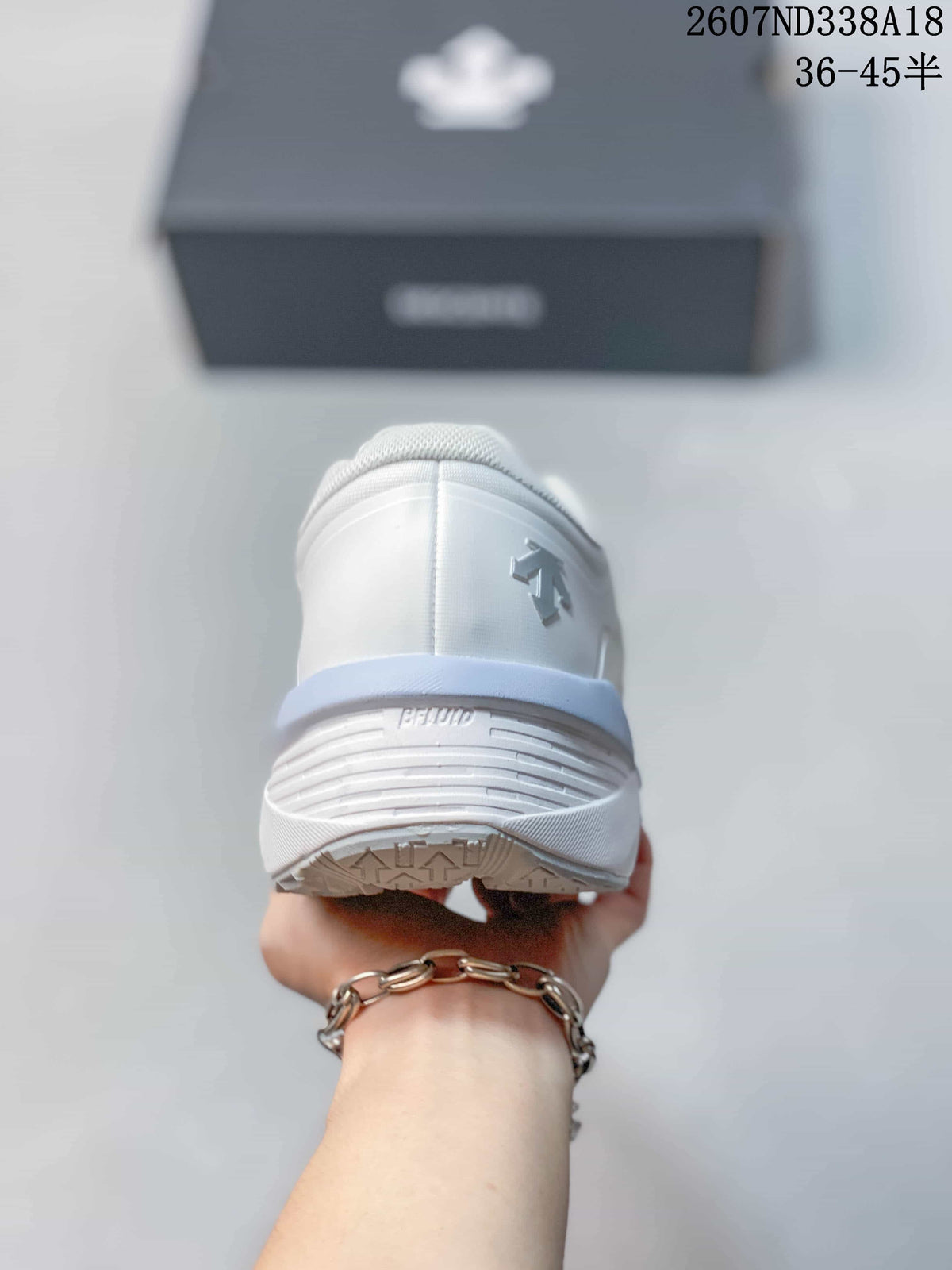 Rear view of the white sneaker showing the padded heel area, raised heel branding and outsole tread.