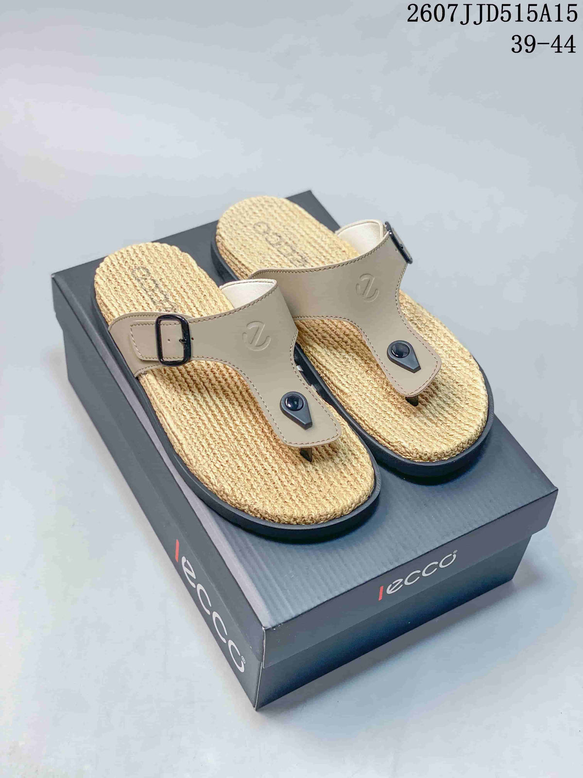 Beige ECCO toe-post sandals with textured woven-look footbeds and adjustable buckles displayed on a branded shoebox.