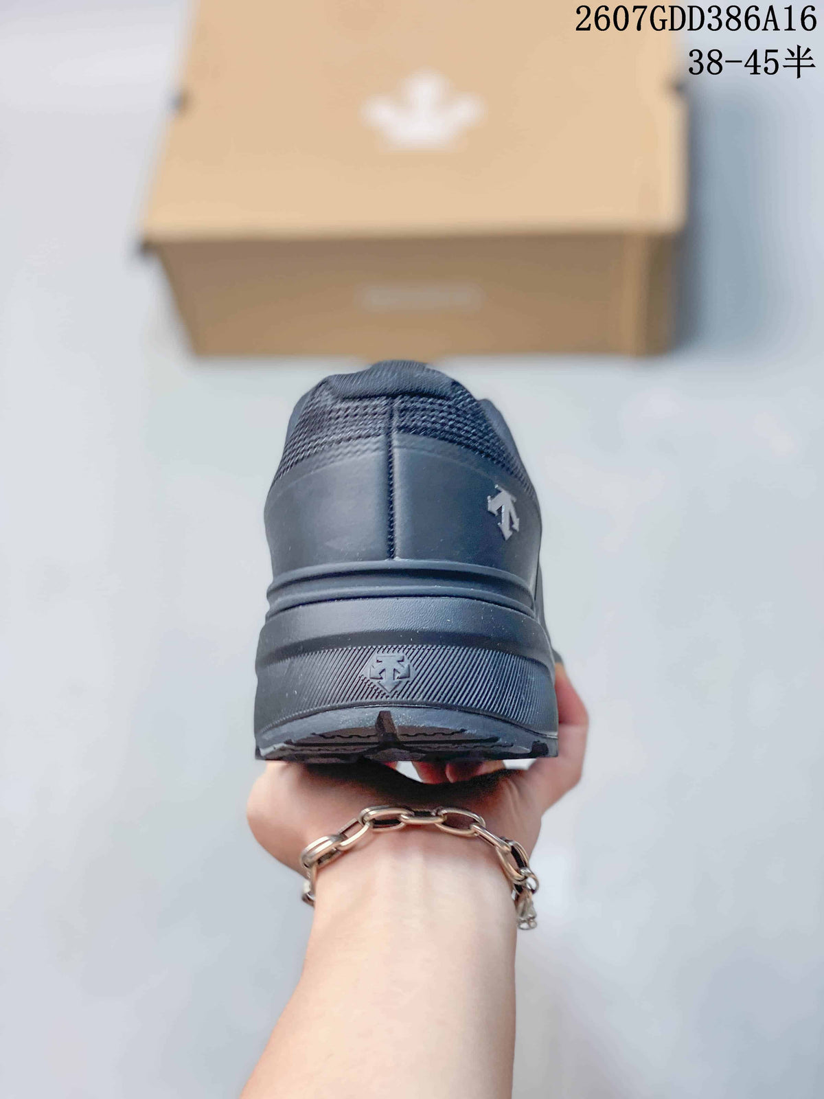 Rear view of the black sneaker showing the heel construction, layered sole, and outsole edge.
