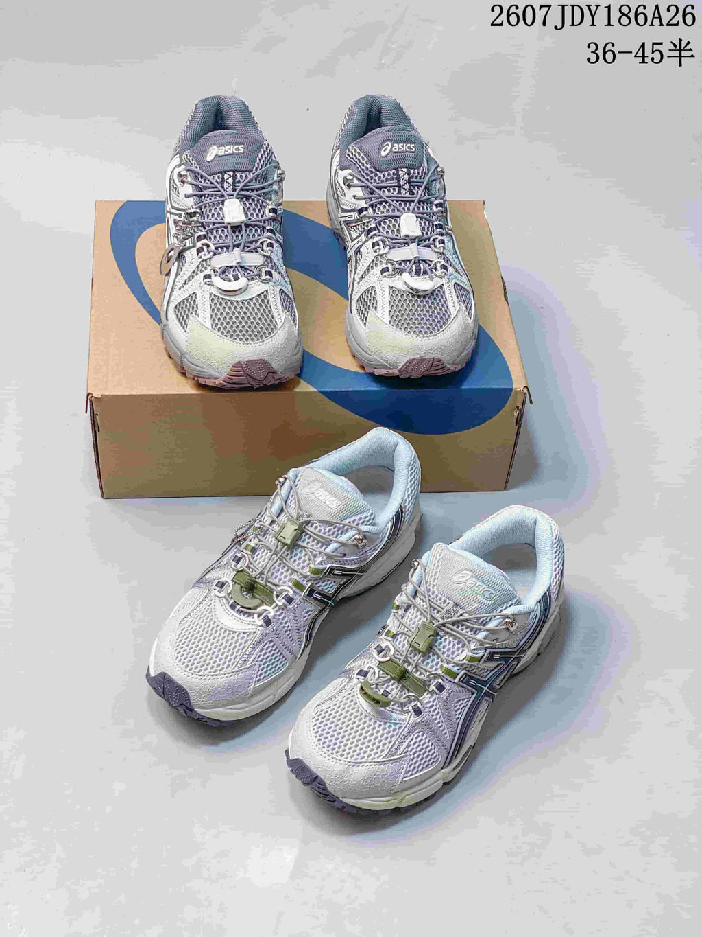 Two pairs of gray and white ASICS Gel-Kahana 8 FL sneakers arranged on and in front of an ASICS shoebox; size range text is visible at the top.