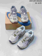 Two pairs of gray and white ASICS Gel-Kahana 8 FL sneakers arranged on and in front of an ASICS shoebox; size range text is visible at the top.