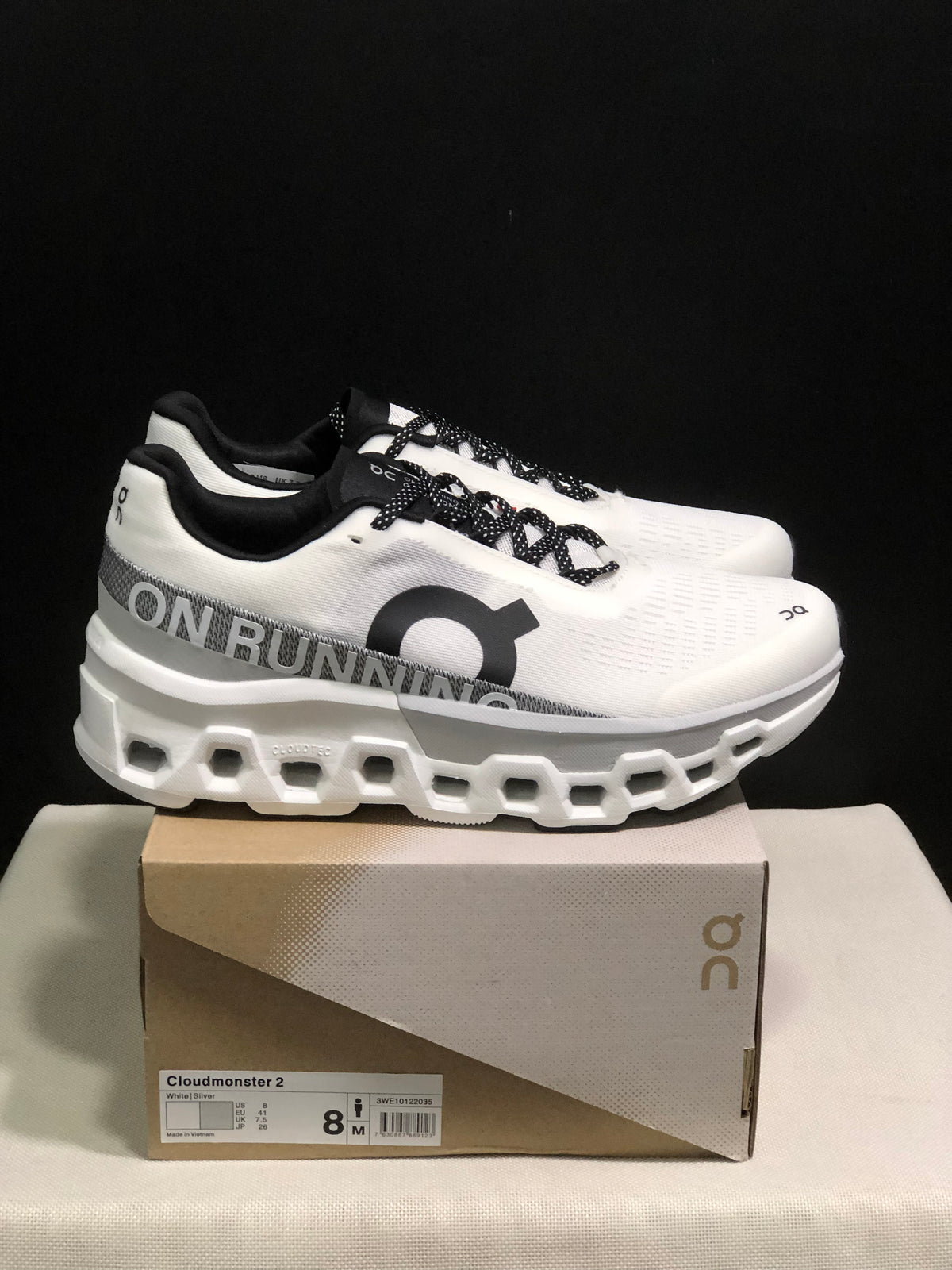Side view of On Cloudmonster 2 shoes on their box