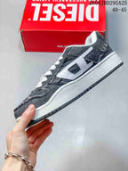 Side view of the charcoal low-top sneaker with a white side logo and white midsole