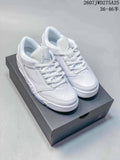 Pair of white Nike Air Jordan Sixty Plus Low sneakers displayed on a black shoebox.
