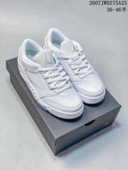 Pair of white Nike Air Jordan Sixty Plus Low sneakers displayed on a black shoebox.