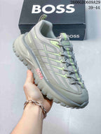 Angled side view of a grey BOSS sneaker with textured panels and lime accents