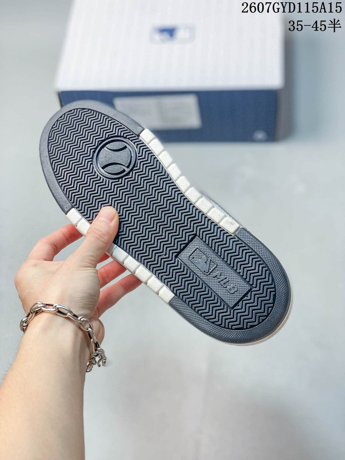 Close view of the sneaker outsole showing a repeating zigzag tread pattern and embossed MLB branding.