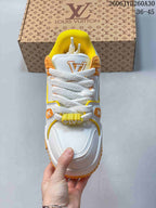 Top view of a white Trainer Maxi sneaker with thick laces and yellow lining.