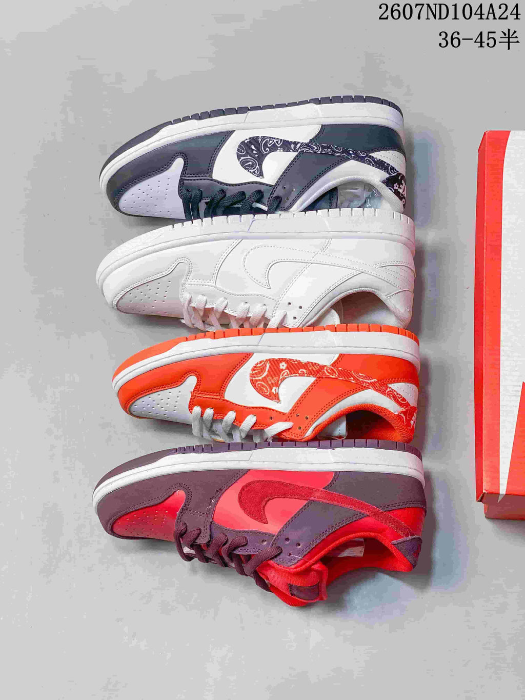 Four Nike SB Dunk Low colorways arranged side by side, including white, white and black, white and orange, and red with dark brown.