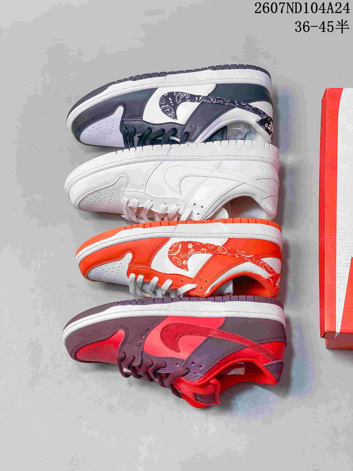 Four Nike SB Dunk Low colorways arranged side by side, including white, white and black, white and orange, and red with dark brown.
