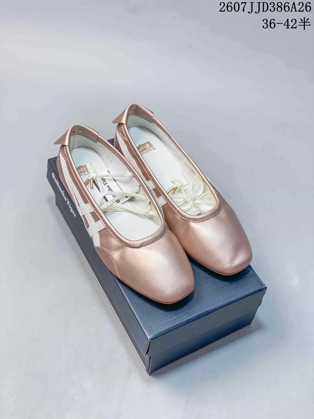 Pair of pink metallic Onitsuka Tiger Mary Jane shoes displayed on a shoe box, with the style code and size range visible above.