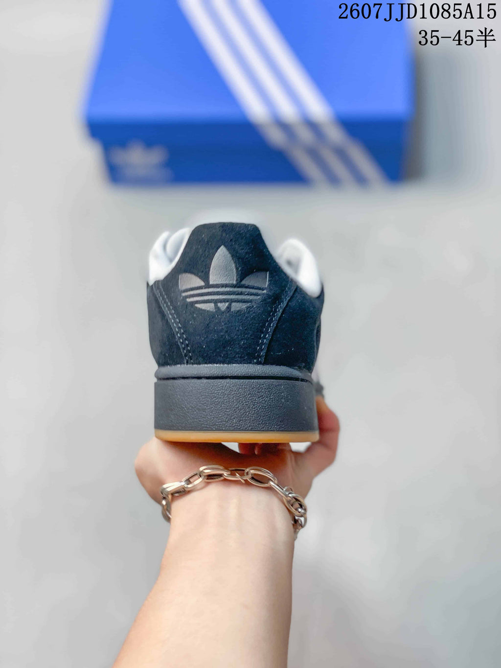 Rear view showing the black heel, white Adidas trefoil branding, and raised sole.