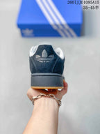 Rear view showing the black heel, white Adidas trefoil branding, and raised sole.