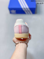 Rear view of the pink sneaker showing the heel panel, white collar detail, and gum-colored outsole.