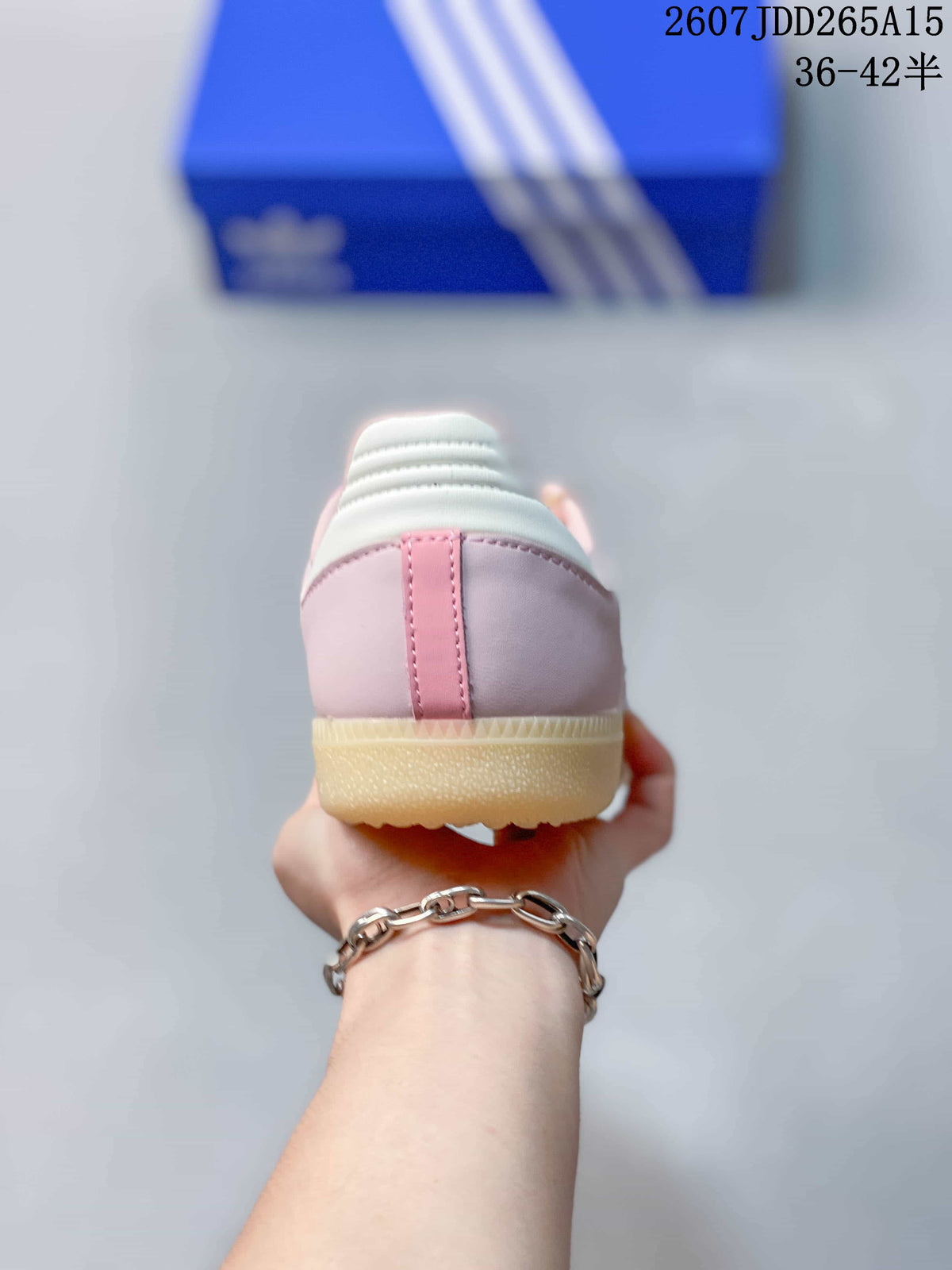 Rear view of the pink sneaker showing the heel panel, white collar detail, and gum-colored outsole.