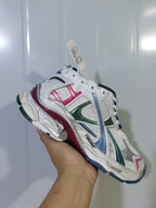 Angled close-up of the Puma 9934 sneaker highlighting the mesh panels, colored overlays, and padded heel.
