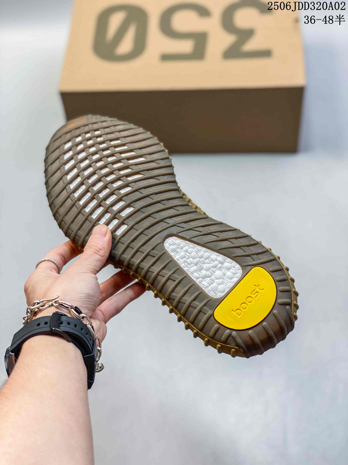 Close-up of the tan ribbed outsole with textured traction sections and yellow and white outsole inserts.