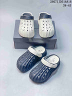 White and navy and navy and white clog colorways arranged together, with logo details visible on the footwear and box.