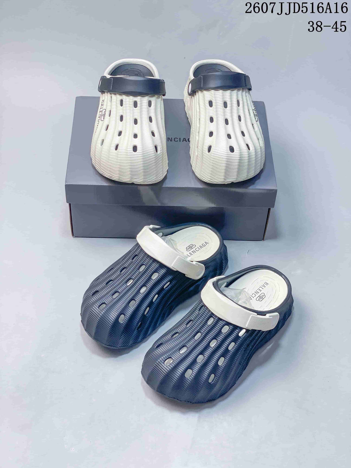 White and navy and navy and white clog colorways arranged together, with logo details visible on the footwear and box.