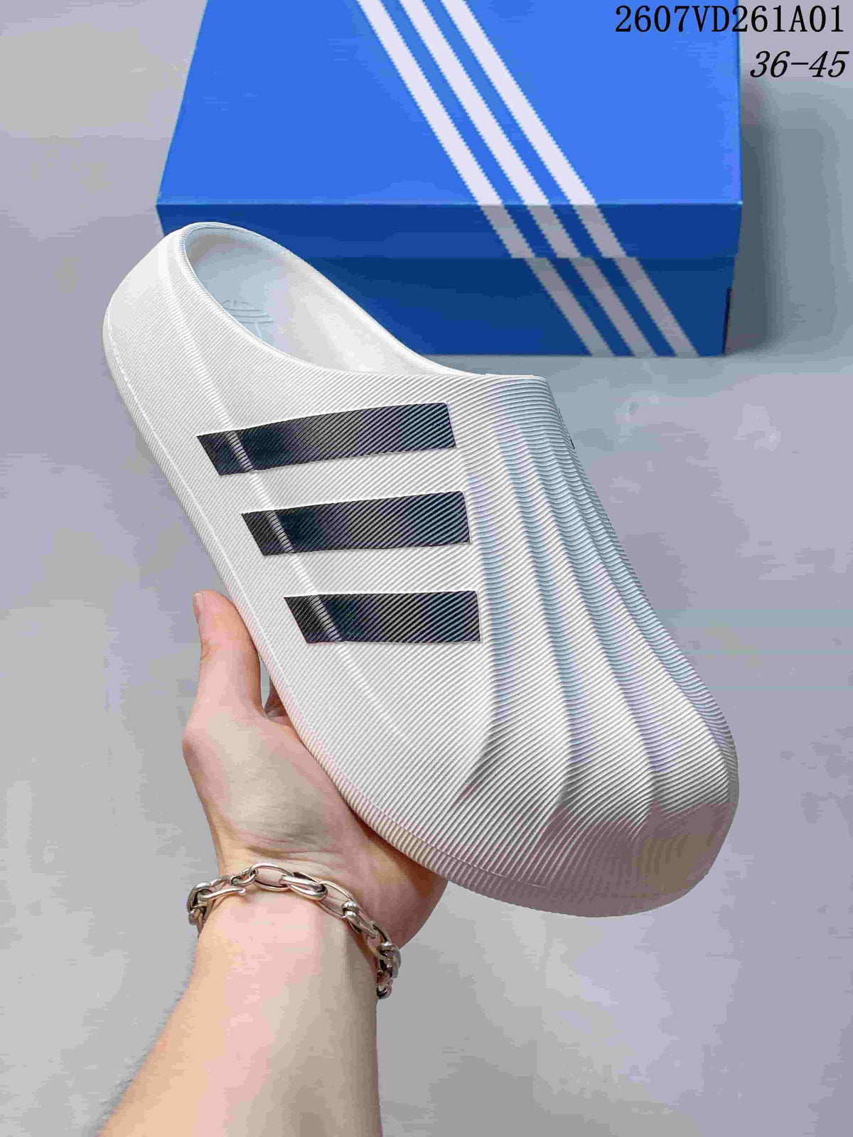 Close side view of the ridged white mule upper and three black stripes