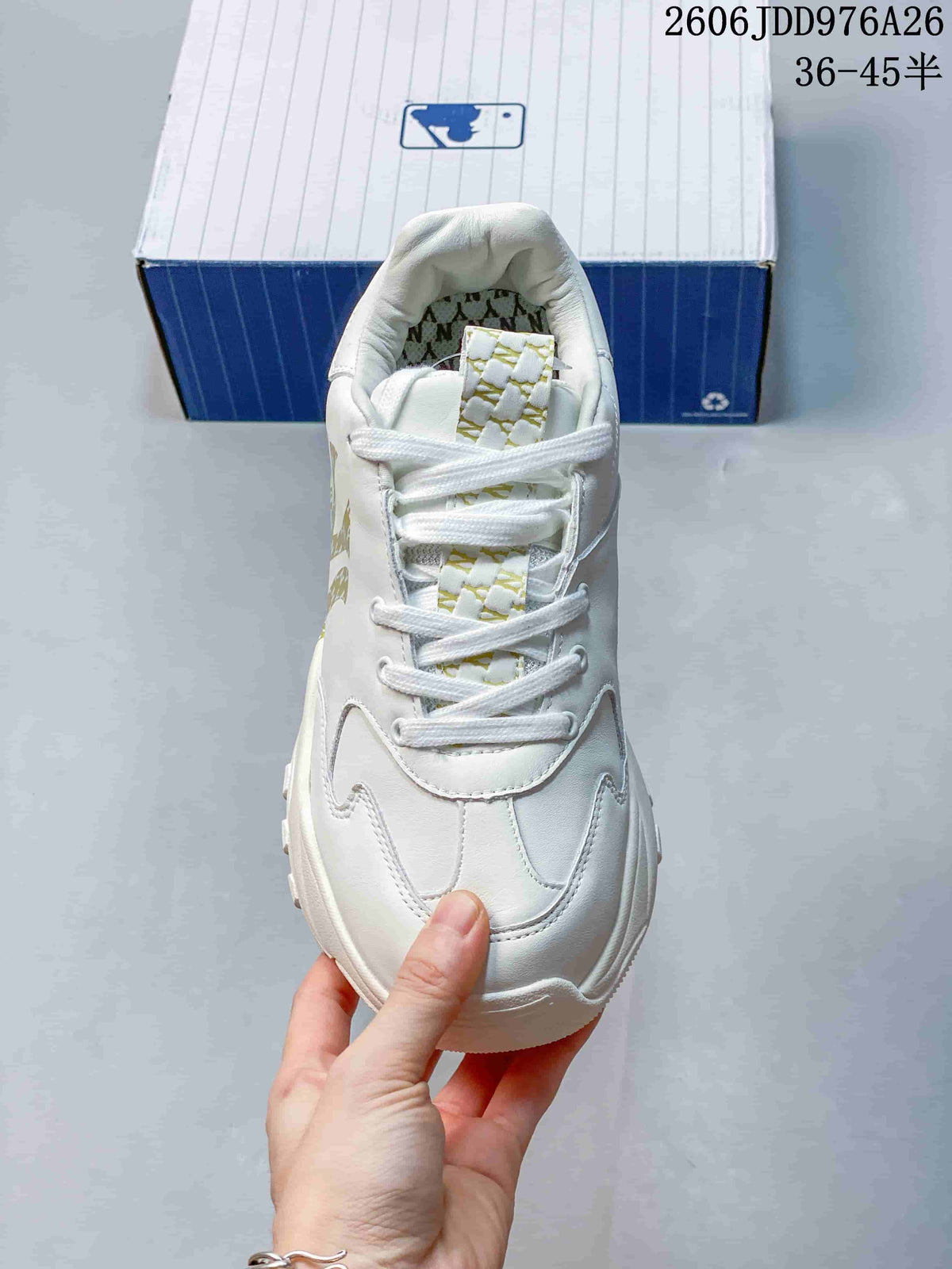 Top view showing the white laces, padded tongue and gold patterned tongue detail.