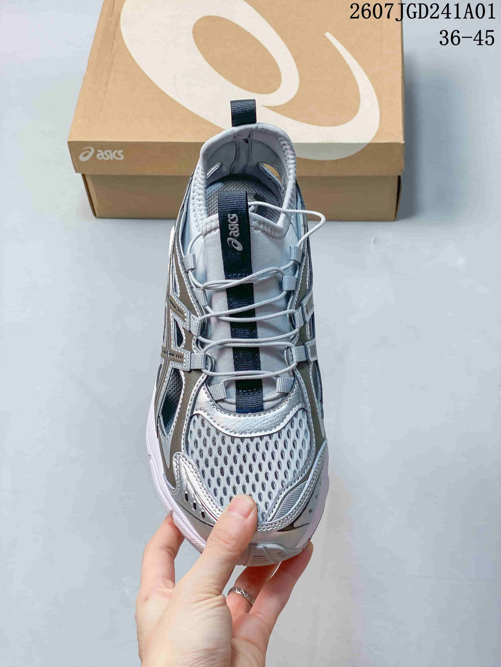 Top view of a silver-toned ASICS GT-2160 Breeze sneaker showing open mesh panels and elastic laces.