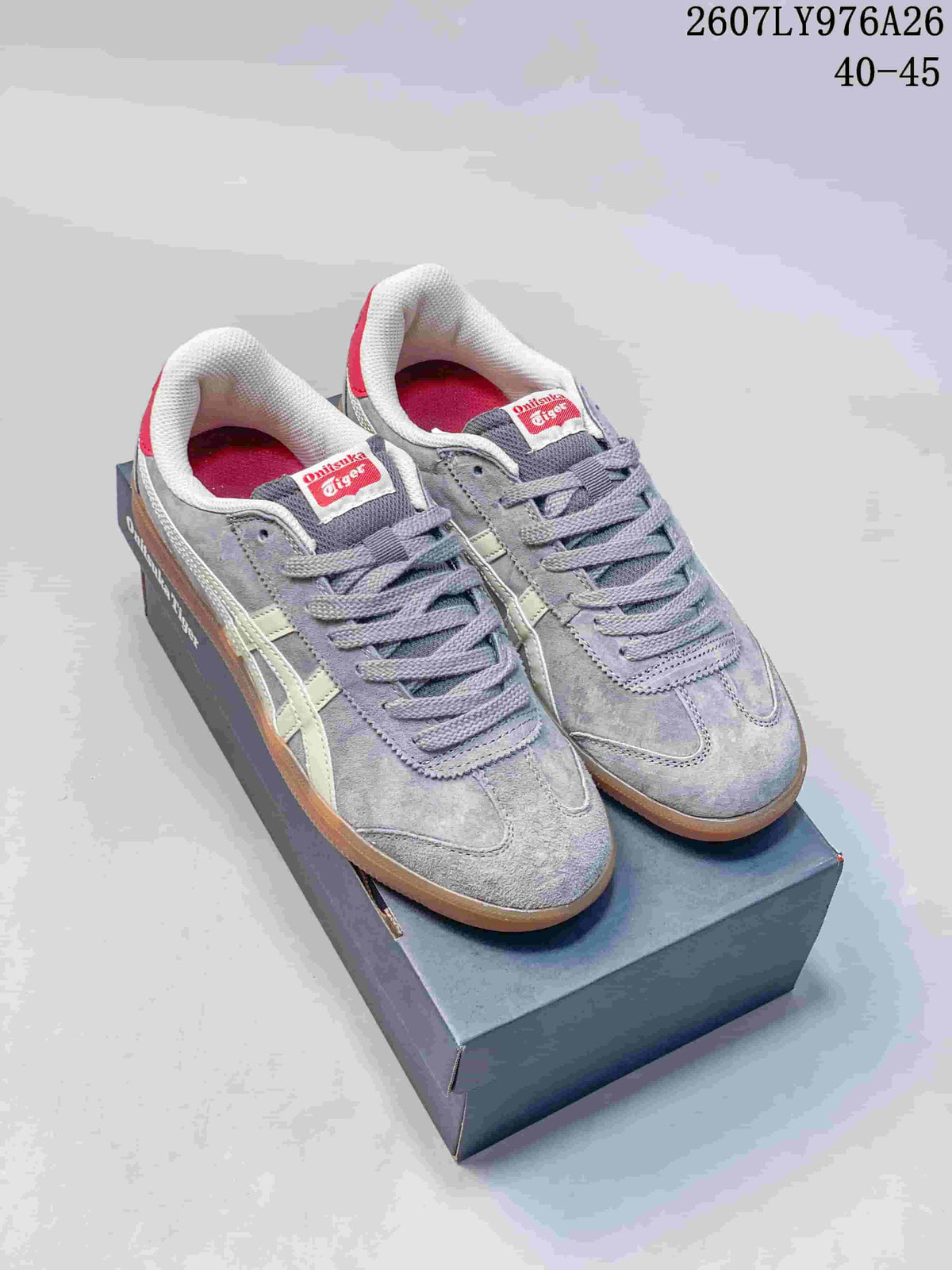 Gray Onitsuka Tiger Tokuten sneakers with cream side stripes, red tongue labels and gum-colored outsoles.