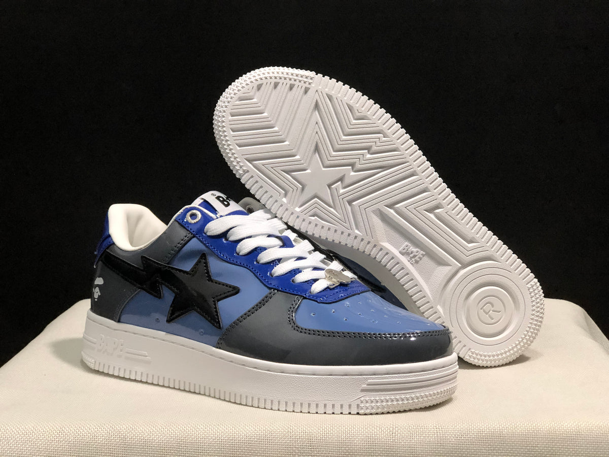 Angled view of the sneakers with one shoe lifted to reveal the patterned white outsole.